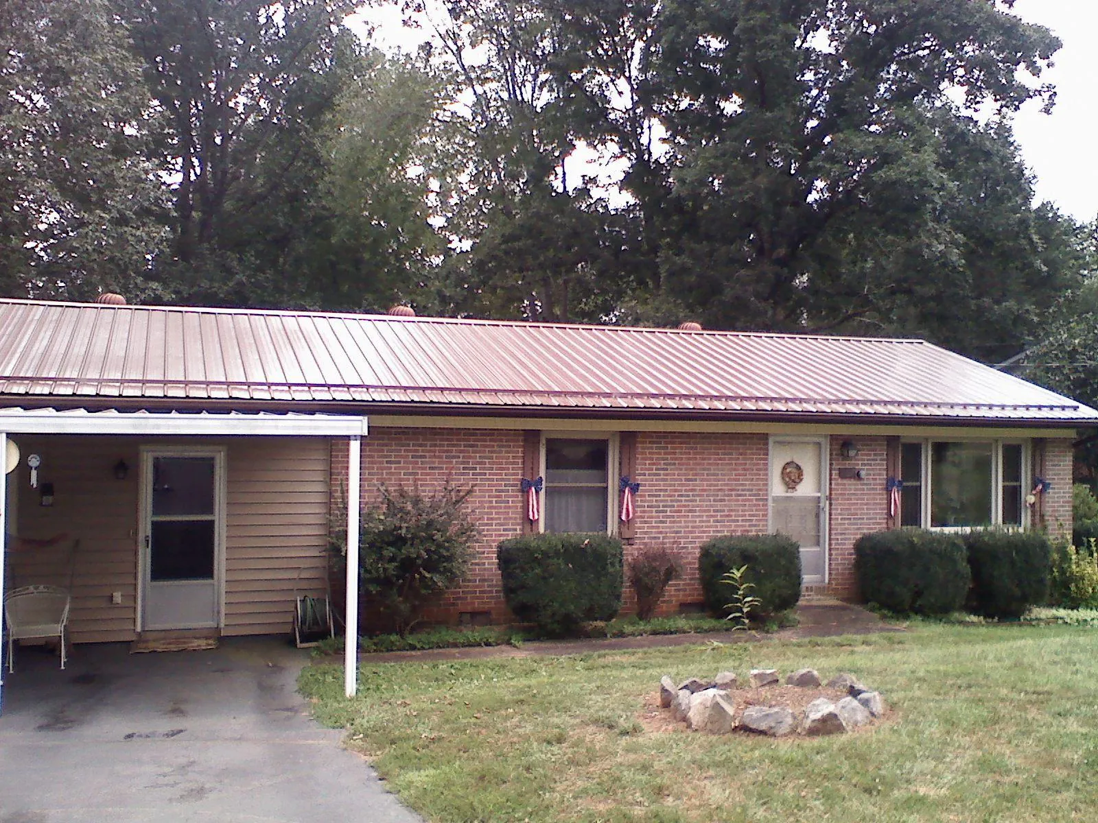 Bronze metal roof and carport on a brick ranch home — Roof Repair work by our crew in New Preston Marble Dale