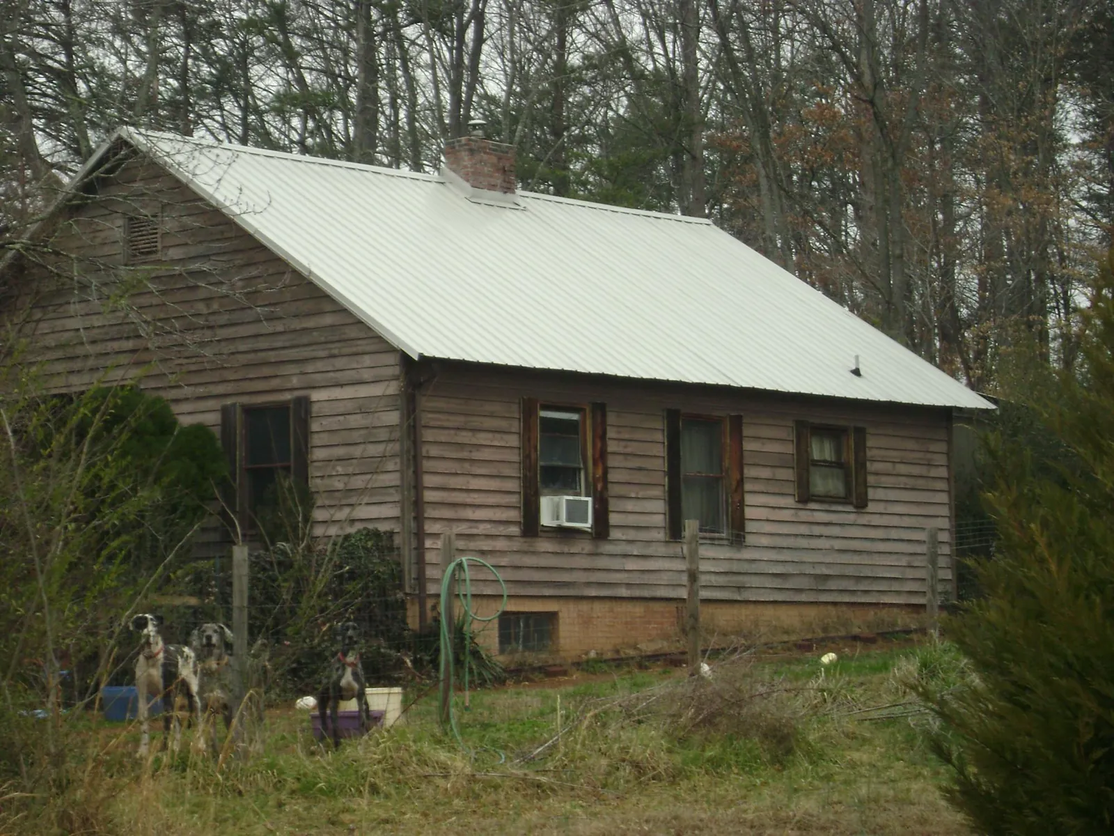 White metal roof on an old wood sided farmhouse, from a Metal Roof Installation job in New Preston Marble Dale